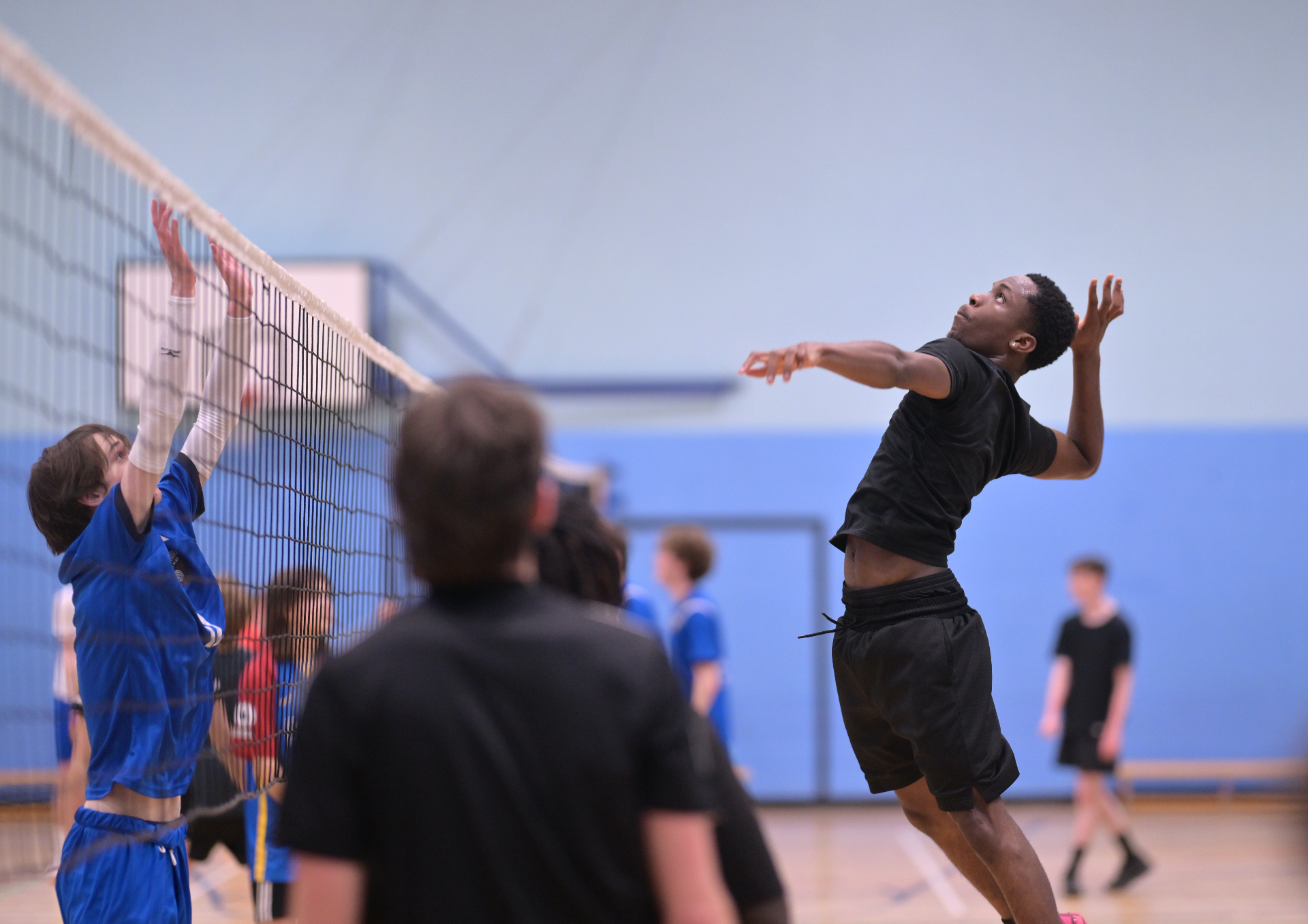 Junior players training at the net